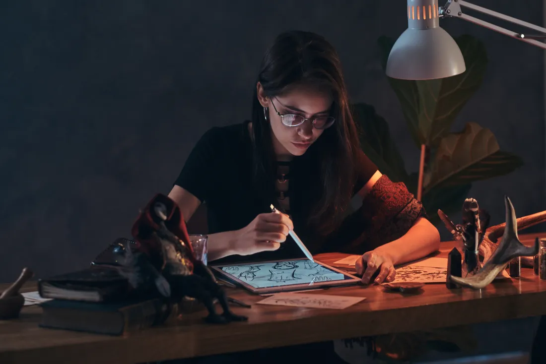 Bachelor of Design student creating a digital illustration on a tablet at Raga